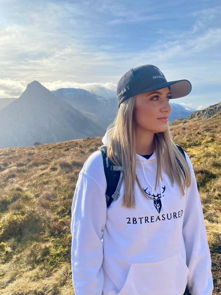 Female model wearing the Embroidered Glen Etive Hoodie white colour on mountain