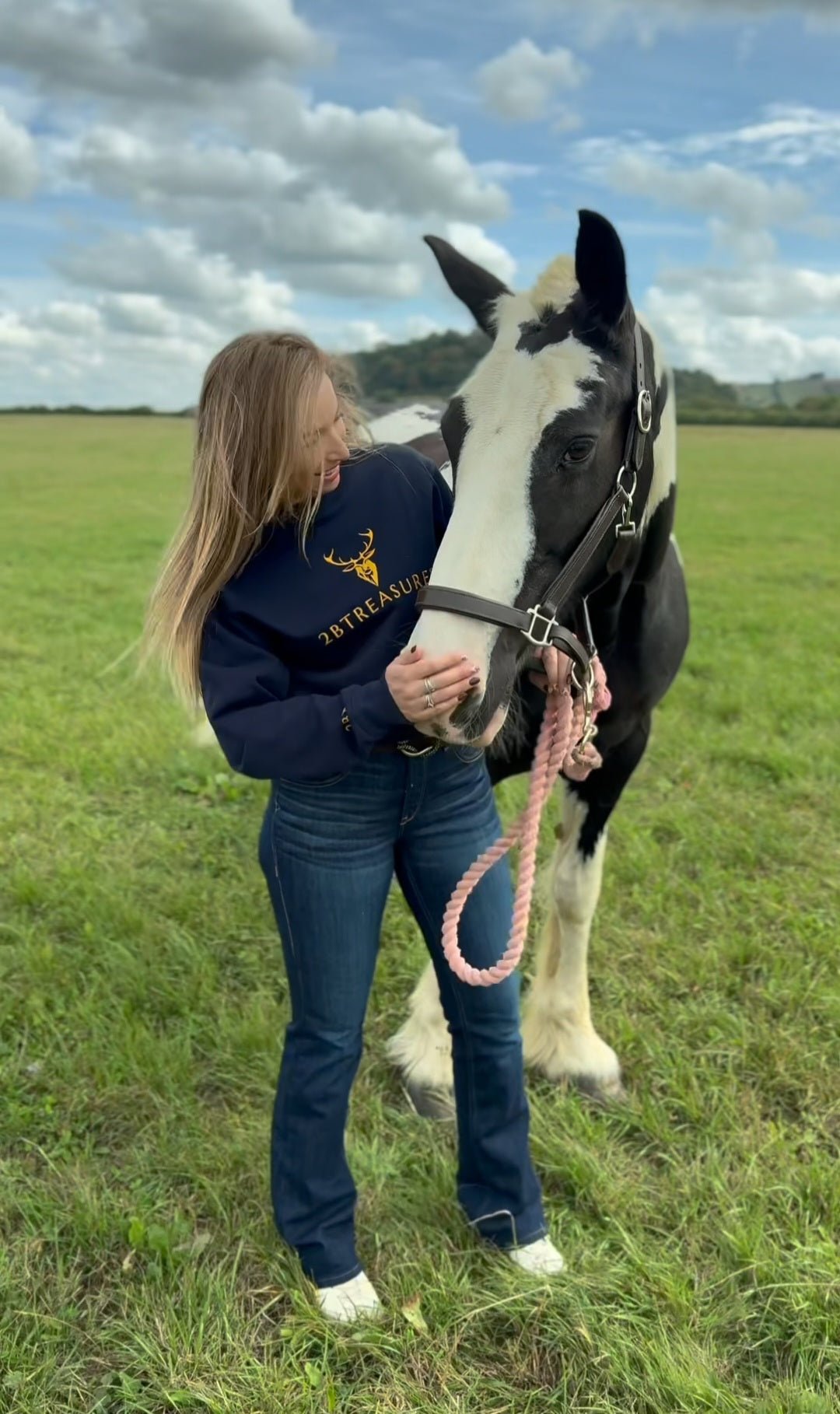 Lady model with horse wearing Embroidered Harris Sweatshirt with gold logo on the front