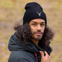 Embroidered Cuffed Beanie worn by a man in a park
