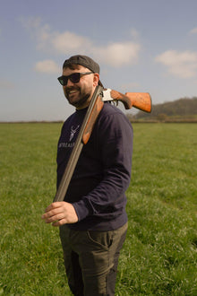 Embroidered Harris Sweatshirt front side view of male model with shotgun in grassy field