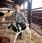 Embroidered Lomond Hoodie modelled by female farmer holding calf