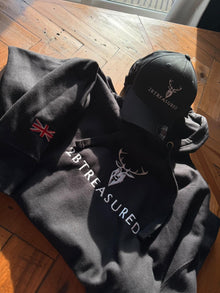 Embroidered Lomond Hoodie with British Flag and 2BTreasured cap resting on a table