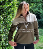 Woman model wearing Embroidered Stagmoor Quarter Zip Country Green in countryside setting front view