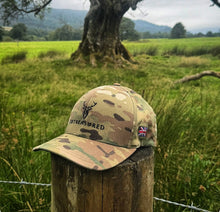 Embroidered Structured Multicam camo cap with British Flag front view resting on a wooden post