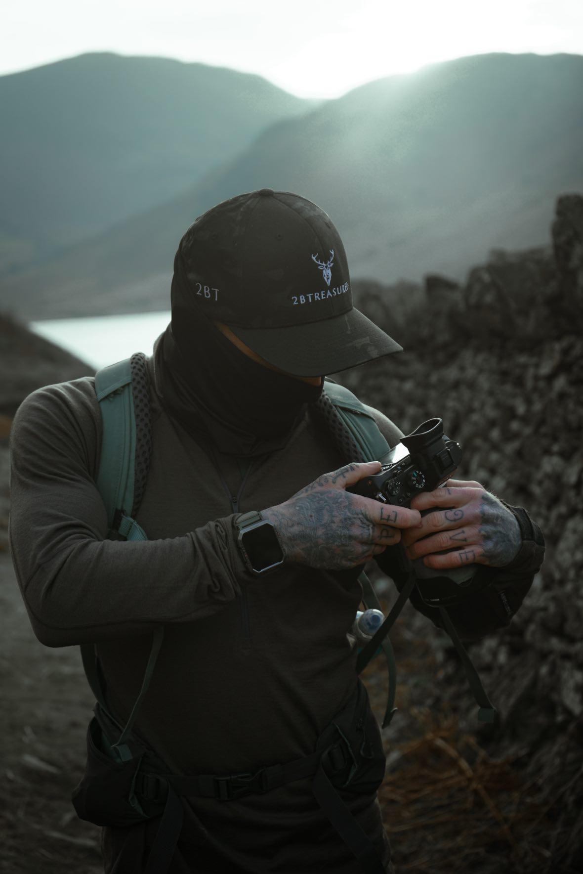 Male with the Embroidered Structured Camo Cap, Multicam with British Flag on a mountain