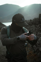 Male with the Embroidered Structured Camo Cap, Multicam with British Flag on a mountain