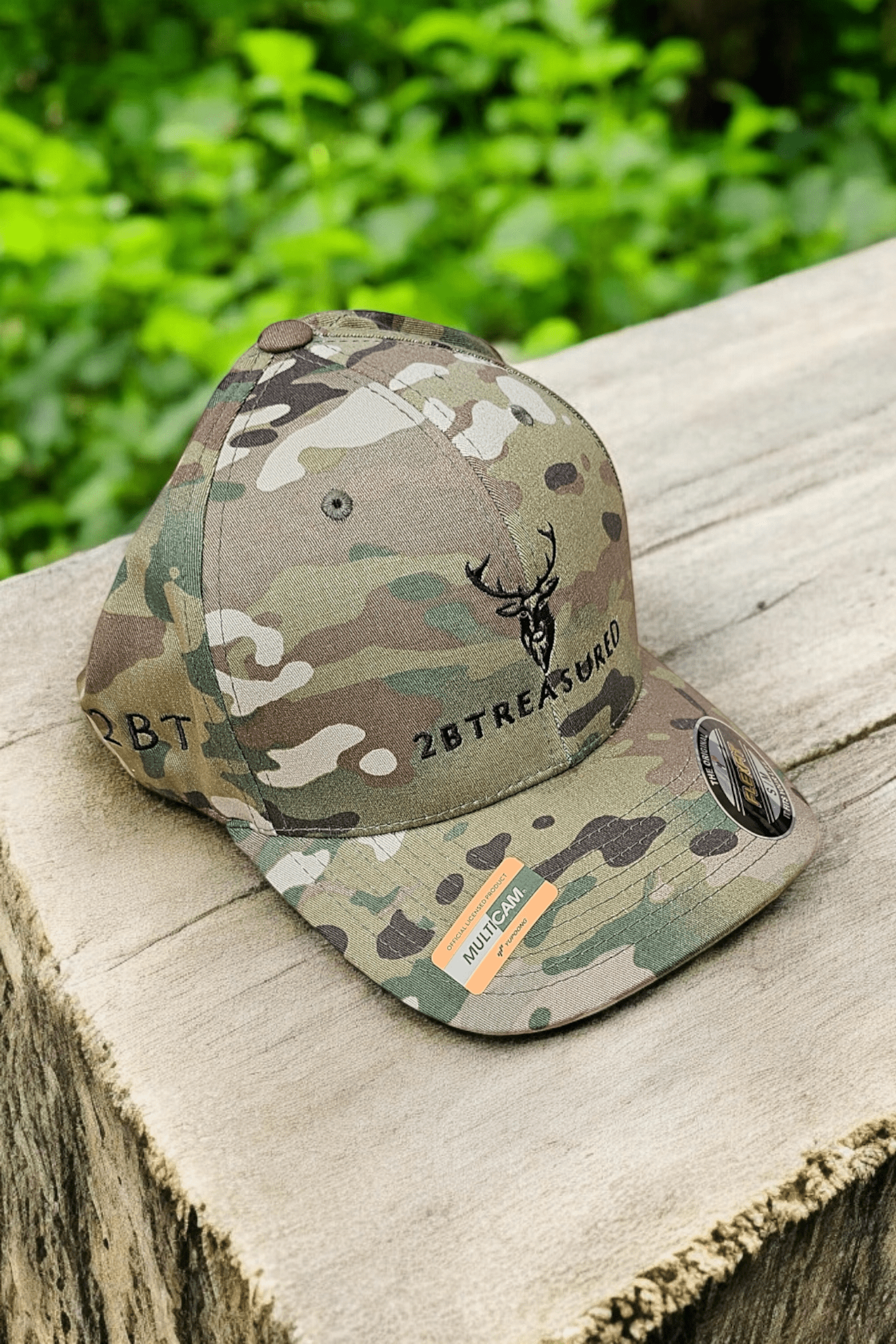 Embroidered Structured Camo Cap with British Flag, Multicam Green on a tree stump side view