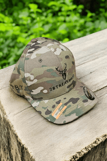 Embroidered Structured Camo Cap with British Flag, Multicam Green on a tree stump side view