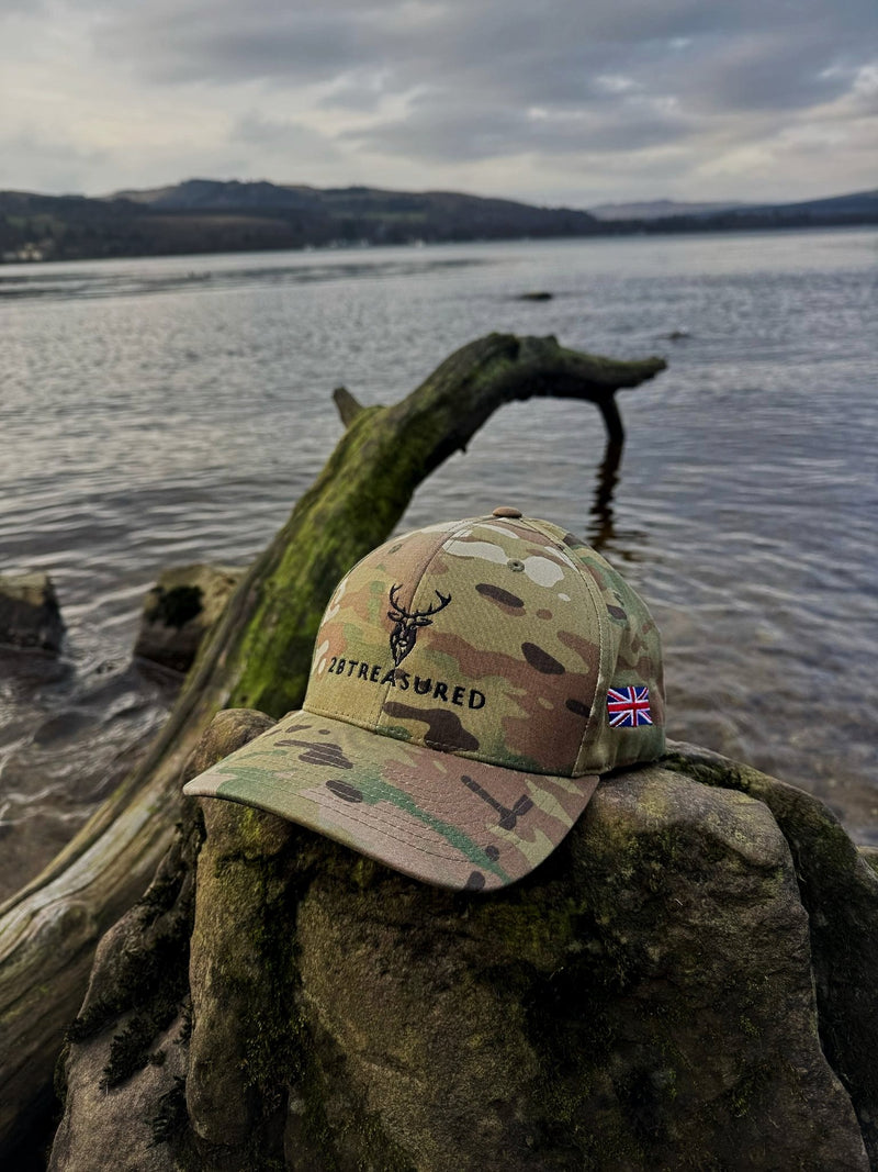 Embroidered Structured Camo Cap with British Flag, Multicam Green from 2BTreasured on a rock beside lake