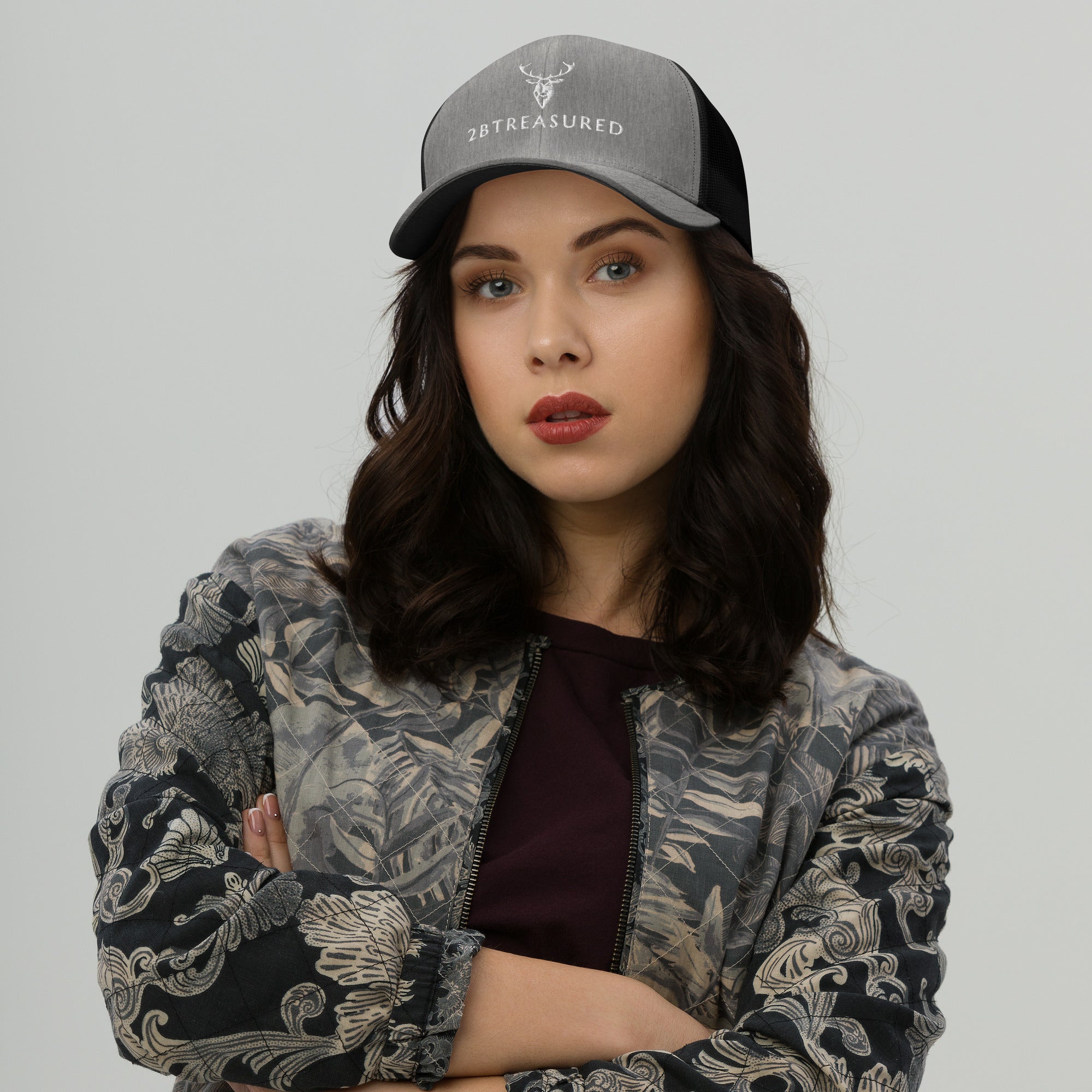 Model wearing the Embroidered Trucker Snapback Cap heather black colour