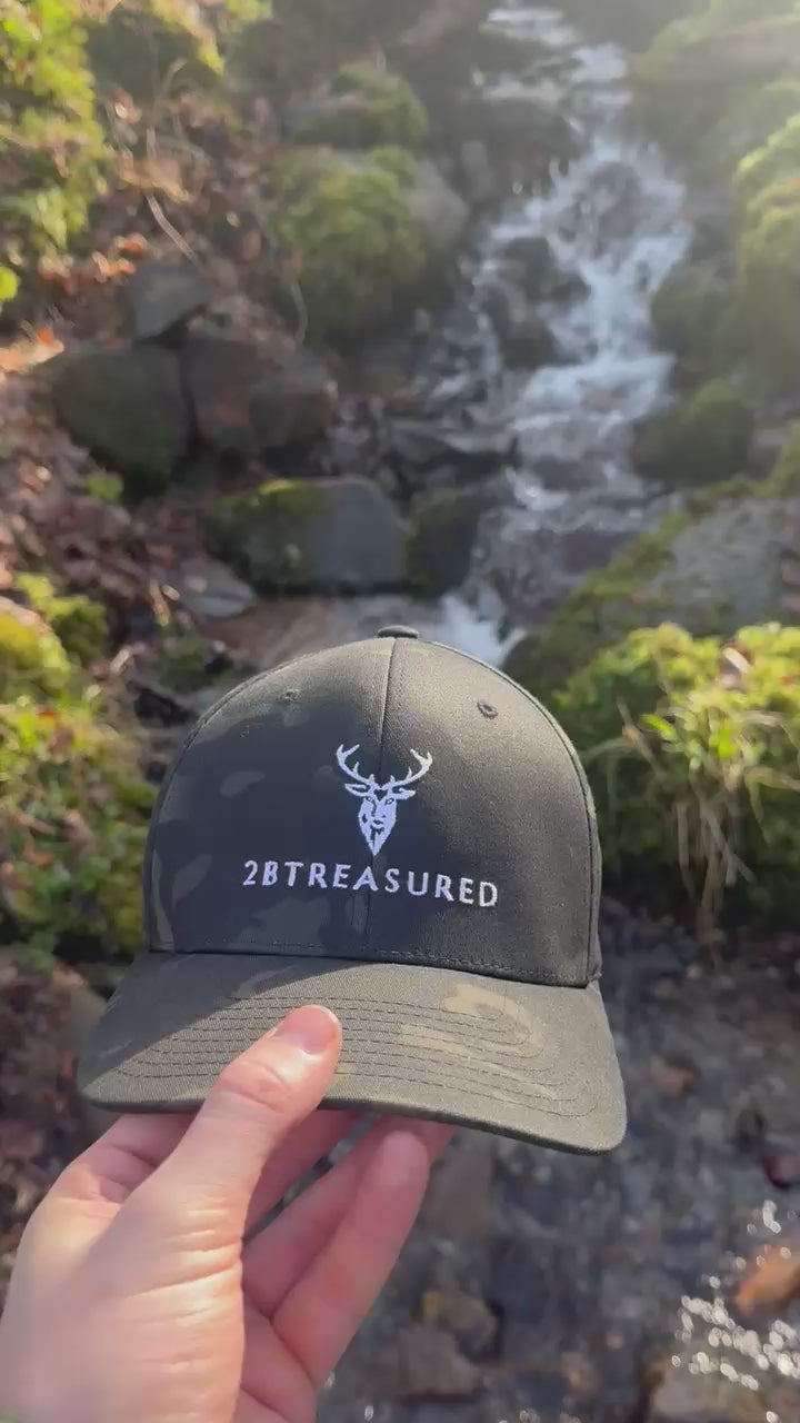 Video showcasing the Embroidered Structured Mullticam Camo Cap with British Flag in a woodland area